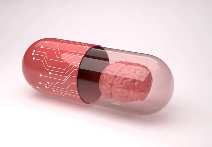 Czerwona kapsułka z obwodami drukowanymi zawiera mózg. Symbolizuje to potencjalne leki, takie jak inhibitory MAO, które wpływają na funkcje mózgu.