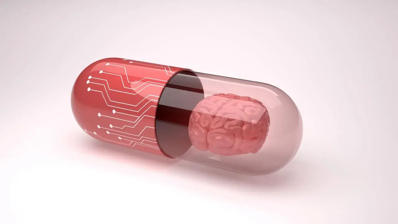 Czerwona kapsułka z obwodami drukowanymi zawiera mózg. Symbolizuje to potencjalne leki, takie jak inhibitory MAO, które wpływają na funkcje mózgu.